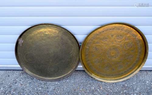 A pair middle Eastern brass embossed chargers 63 cm (2)