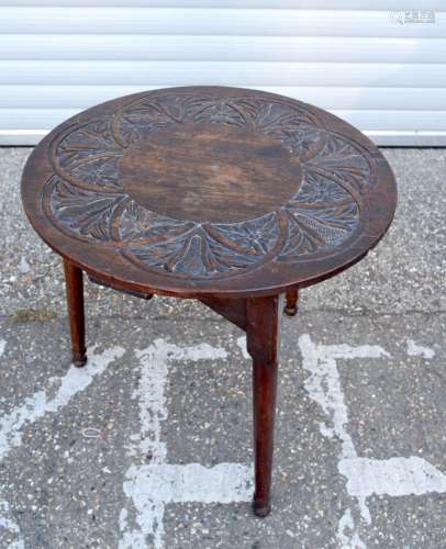 An antique oak cricket table with a carved top 72 x 72cm .