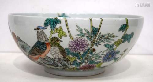 A large Chinese porcelain bowl decorated with birds and foli...