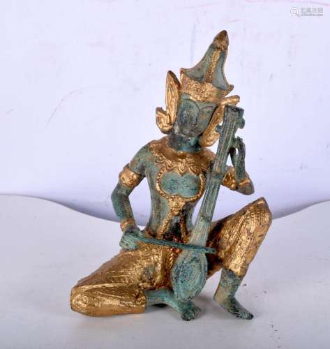 A small South East Asian bronze musician with gilt decoratio...