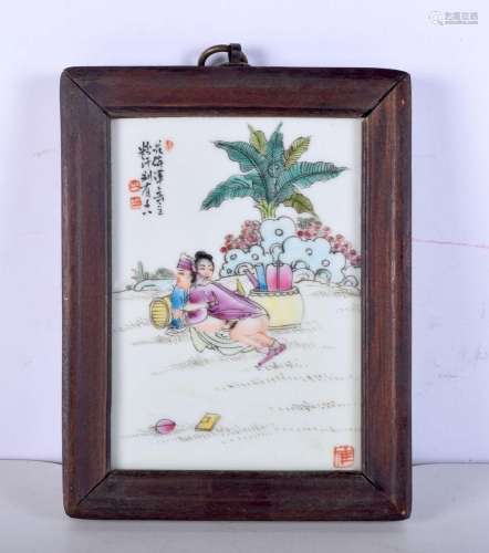 A Chinese porcelain hardwood framed tile depicting a couple ...