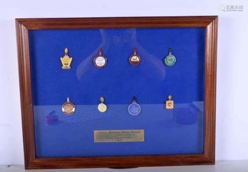 A framed collection of racecourse badges from the 1950s and ...