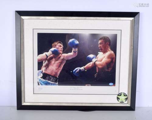 A framed, signed and authenticated boxing photograph of Rick...