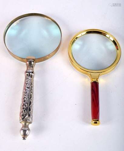 A large white-metal handled brass encased magnifying glass, ...