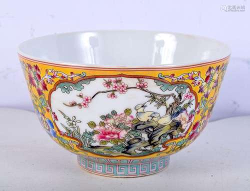 A small Famille Jaune bowl decorated in panels with birds an...