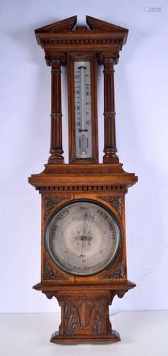 A large wooden aneroid barometer and thermometer. 93 x 31cm.