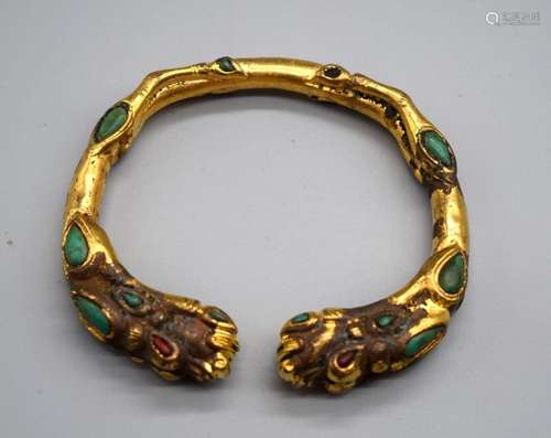 A Chinese gilt metal beast head bracelet decorated with turq...