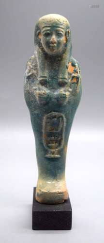 A glazed pottery figure of an Egyptian Pharoah 16 cm.