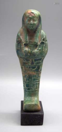 A glazed pottery figure of an Egyptian Pharoah 15 cm.