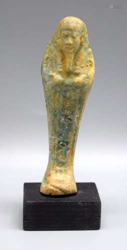 A glazed pottery figure of an Egyptian Pharoah 11 cm.