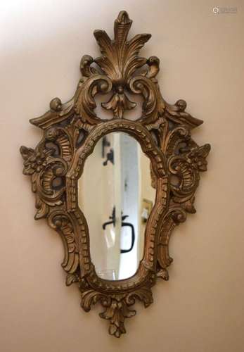 AN EARLY 20TH CENTURY GILTWOOD MIRROR of scrolling form. 63 ...