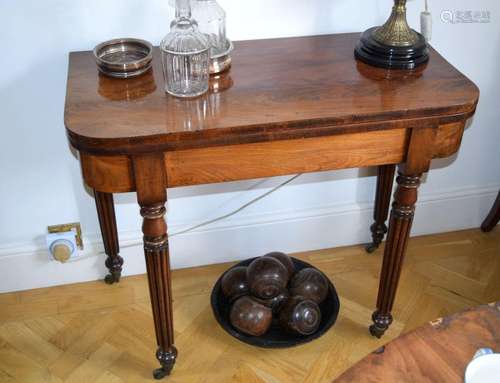 A GEORGE III MAHOGANY FOLD OVER CARD TABLE with green baise ...