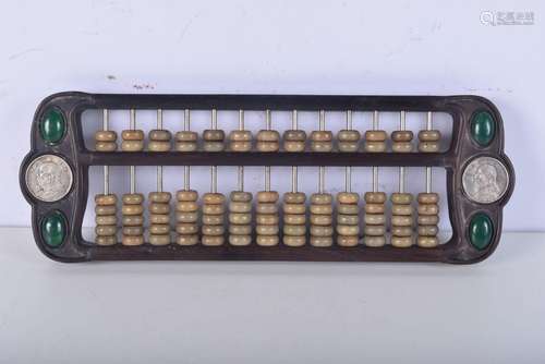 A Chinese hard stone abacus within a hardwood frame 14 x 42c...