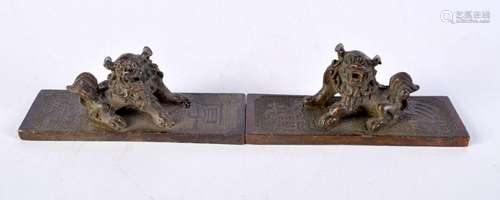 A pair of Chinese scroll weights in the form of lions 4 x 11...