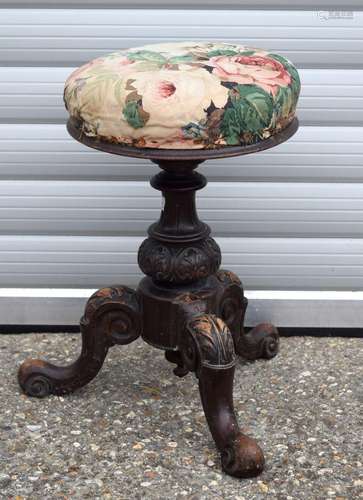 AN ANTIQUE PIANO STOOL. 54 cm high.