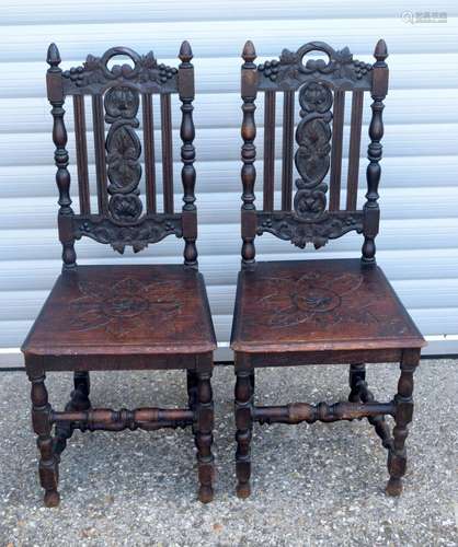 A PAIR OF BLACK FOREST VICTORIAN HALL CHAIRS. 105 cm high.