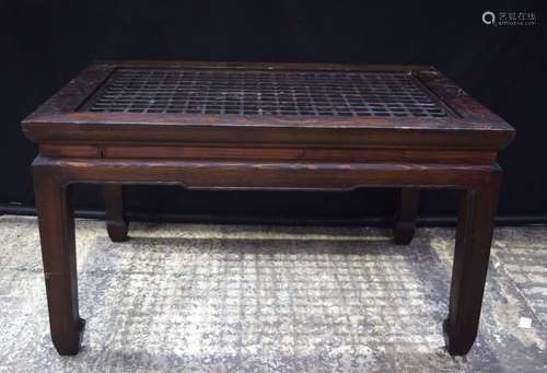 A small Chinese hardwood table with lattice work top 46 x 81...