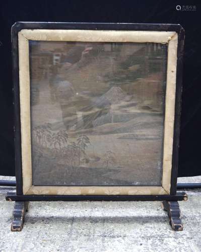 A Japanese silk depicting Mount Fuji mounted in a free stand...