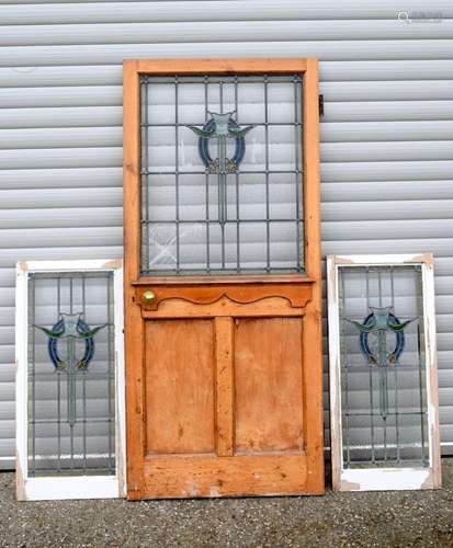 A set of stain glass panels set within a door and window fra...