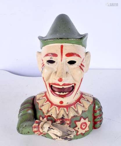 A vintage cast iron novelty money box in the form of a clown...