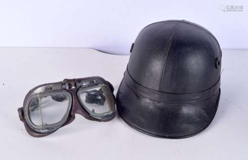 A vintage motor cycle helmet together with a pair of goggles...