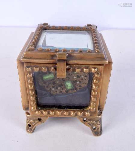 A small brass and bevelled glass top opening jewellery box t...