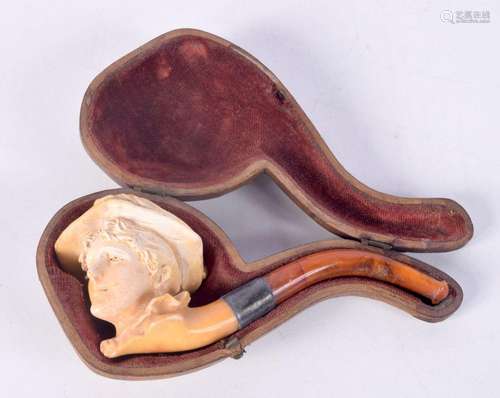 A cased Meersham pipe in the shape of a ladies head with amb...