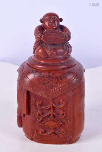 A Chinese lacquered pot with a seated Buddha lid.13 cm.