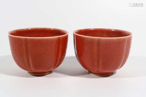 A pair of coral red cups