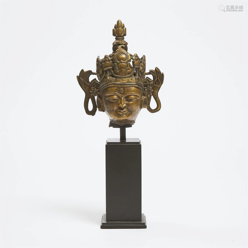 A Tibetan Bronze Head of Buddha, 15th Century, overall with