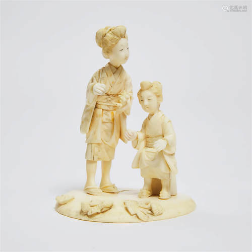 A Japanese Ivory Okimono of A Mother and Child at a Lotus P