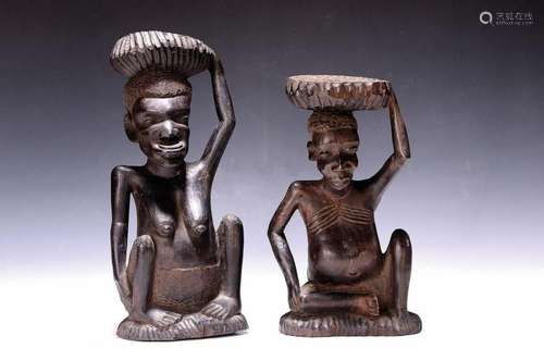 Two ancestor sculptures, male and female in a stylistic