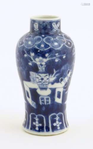 A small Chinese blue and white vase decorated with flowers i...