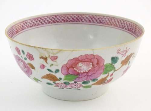 A Chinese famille rose bowl decorated with flowers and folia...