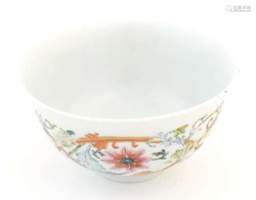 A small Chinese famille rose bowl decorated with scrolling f...
