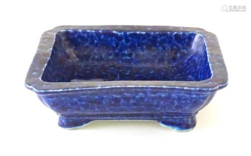 A Chinese dish of rectangular form with a blue glaze, raised...