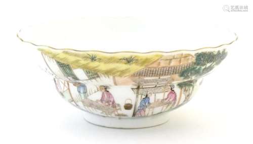 A Chinese stepped bowl decorated with figures in a landscape...