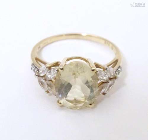 A 9ct gold dress ring set with central oval serenite flanked...