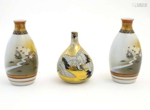 Three Japanese vases, comprising a pair decorated with a lan...