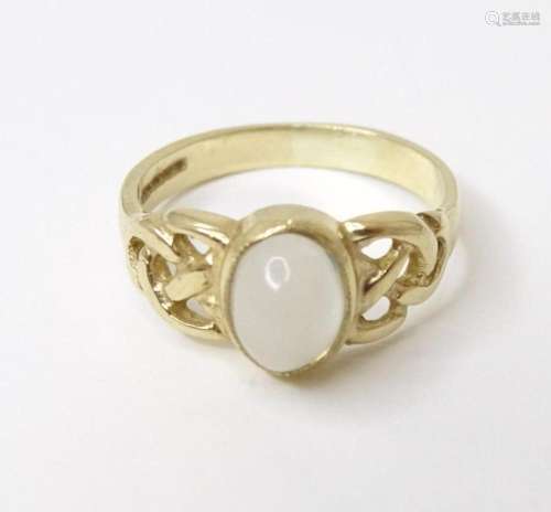 A 9ct gold ring set with central moonstone cabochon. Ring si...