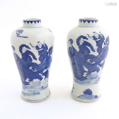A pair of Chinese blue and white vases decorated with a Chin...