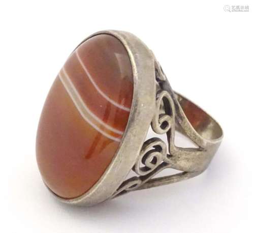 A silver dress ring set with agate cabochon. Hallmarked Lond...