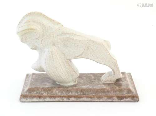 A French Art Deco model of a ram with a crackle glaze on a s...