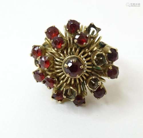 A yellow metal ring marked 18k set with garnets. Ring size a...