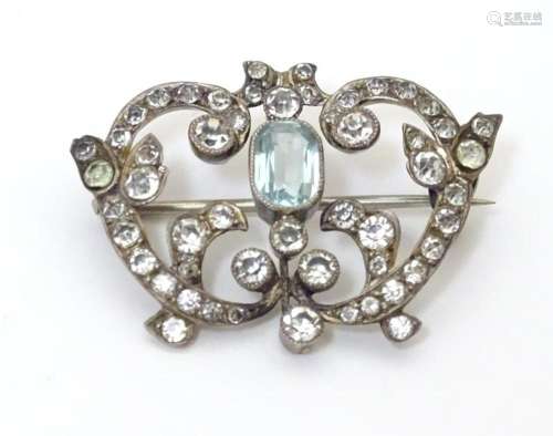 A vintage brooch set with blue and white paste stones. Appro...