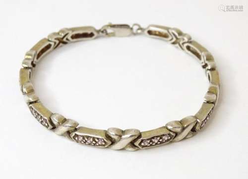 A .925 silver bracelet set with pink paste detail 7 1/2"...