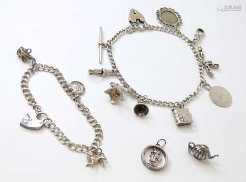 A silver charm bracelet set with various silver and white me...