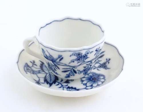 A Meissen blue and white cup and saucer in the onion pattern...