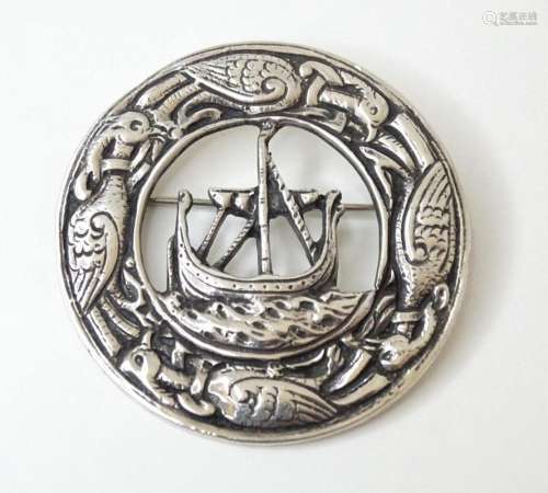 A silver brooch with Iona style decoration depicting longboa...