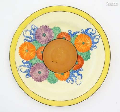 A Clarice Cliff plate decorated in the Gayday pattern with f...